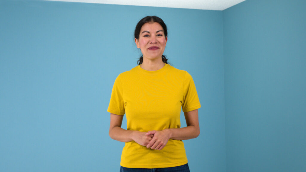 painter smiling look directly at the camera, yellow shirt