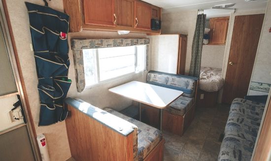 picture of RV eating area, table inside the RV, before the remodel