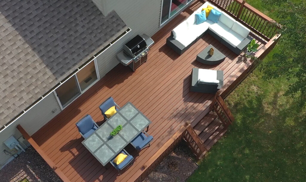 stained deck outside with furniture on it
