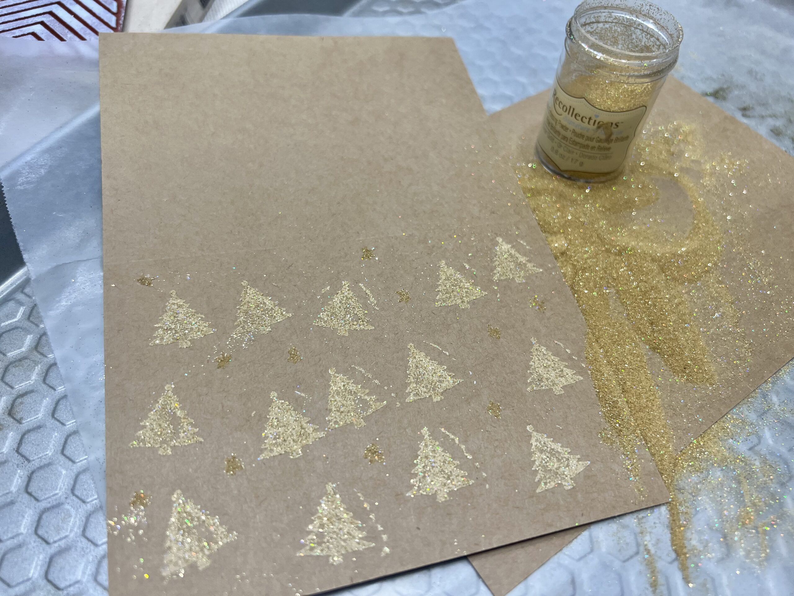 Embossed mini gold Christmas trees on a card